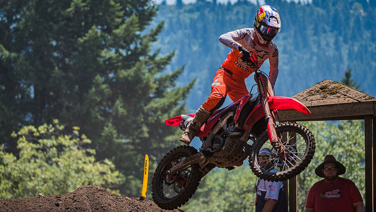 Jett Lawrence on a red Honda in the air over a jump at the 2021 Washougal National